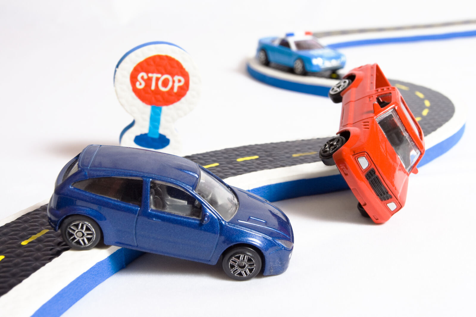 A toy car beside an insurance policy document