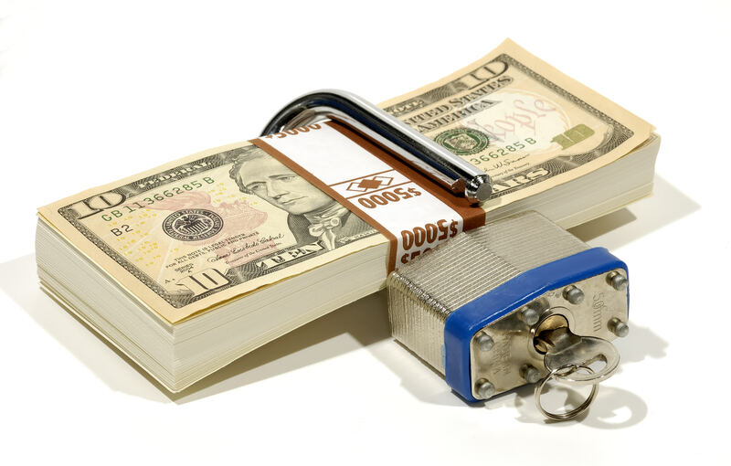 A padlock securing a stack of money, representing protection against digital financial loss